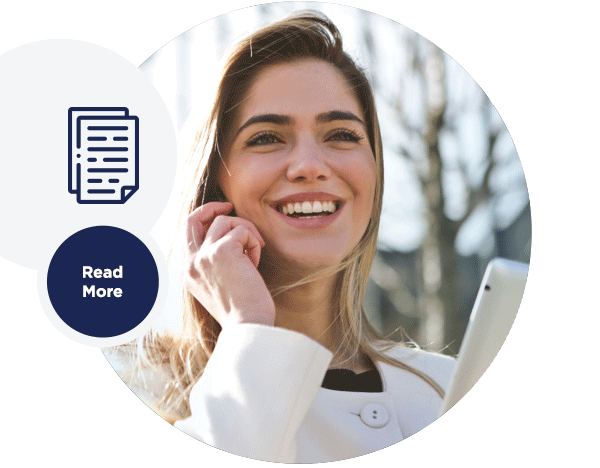 Image of a woman smiling while using a mobile phone.