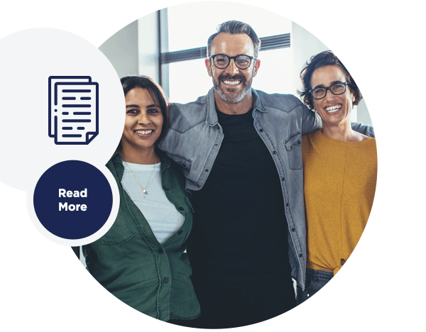 A group of 3 smiling people in an office.